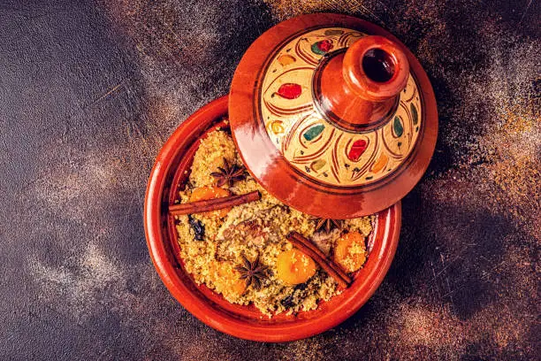 Traditional moroccan tajine of chicken with salted lemons, olives. Top view.