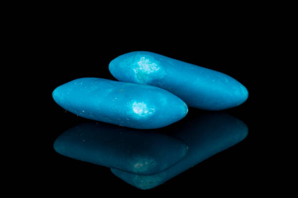 istock Blue chewing gum isolated on black glass 1204622276