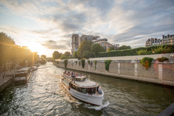 istock Boat on River behind Notre Dame 1204622593