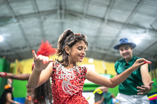 Little cute girl celebrating and dancing brazilian carnival