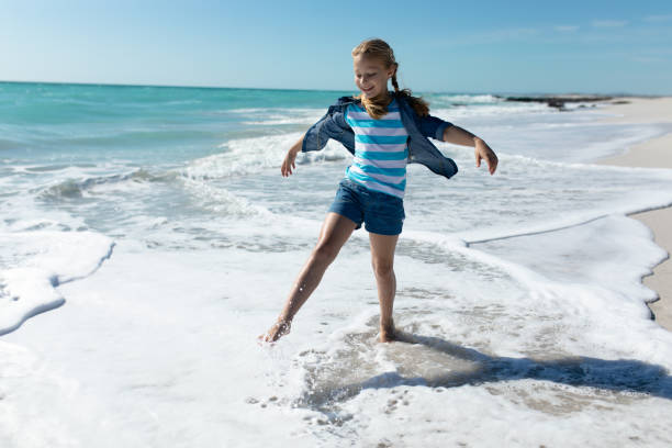 istock Girl playing at the beach 1204624470