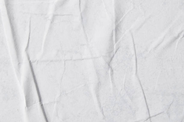 Creative background with scattered overlay of crumpled papers.