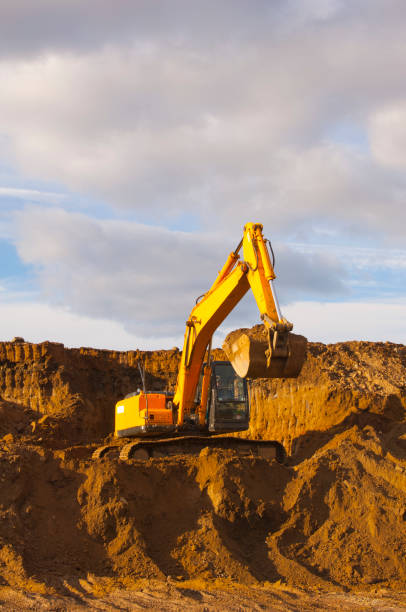 istock Excavator works in a quarry. Construction machinery. 1204625103