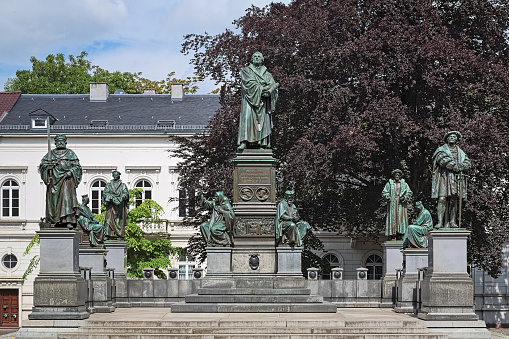 Martin Luther Monument in Worms, Germany. The monument was unveiled on June 25, 1868. The overall design of the monument was by the German sculptor Ernst Rietschel (1804-1861), who made the statue of Luther also. The other statues were executed by his pupils: Adolf von Donndorf (1835-1916), Johannes Schilling (1828-1910), Gustav Adolph Kietz (1824-1908). Architect Georg Hermann Nicolai (1812-1881) was also involved. The German text on the pedestal reads: \