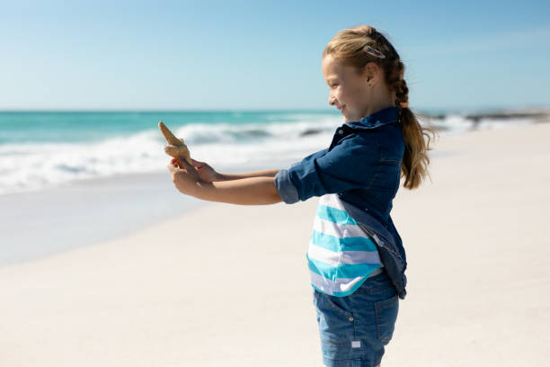 istock Girl smiling at the beach 1204625890