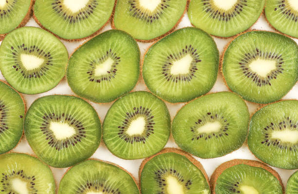 istock Juicy kiwi fruit slices background 1204626337
