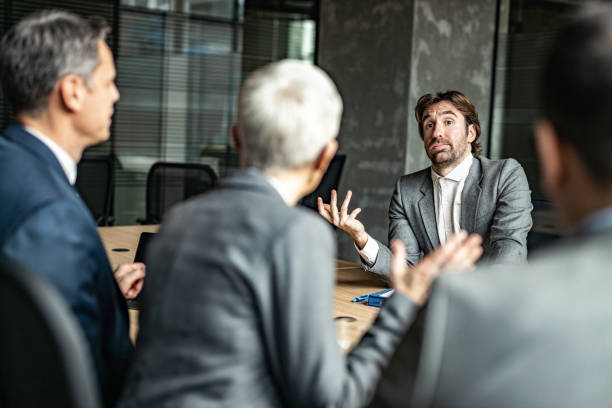 istock Uncertain male candidate talking to human resource team on a job interview. 1204626430