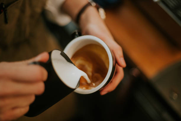 Barista hand while making latte ate with cappuccino menu at the cafe, routine, part-time job, small business