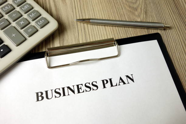istock Business plan with pen and calculator 1204626567