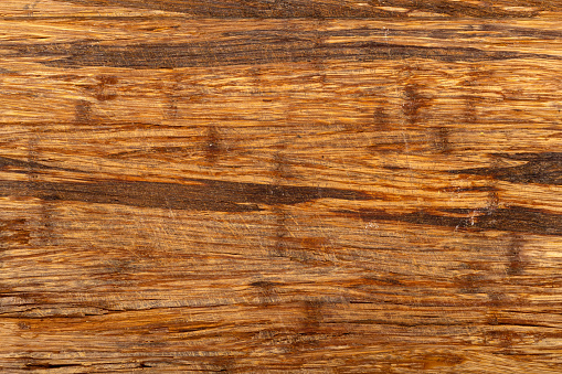 Old scratched wooden cutting board texture background.