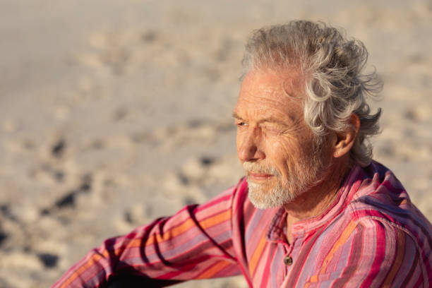 istock Old man relaxing at the beach 1204627963