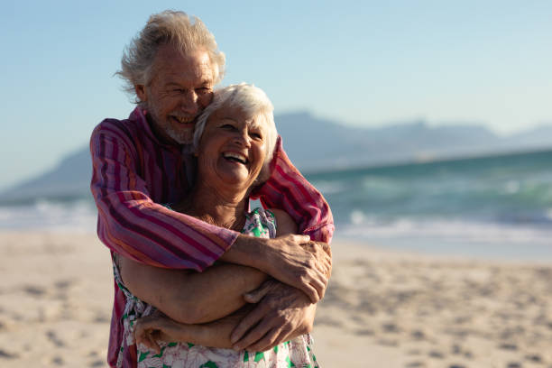 istock Old couple in love at the beach 1204628040