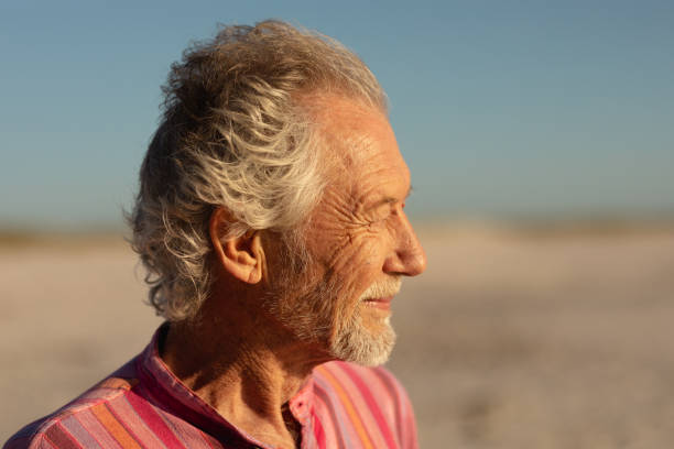 istock Old man relaxing at the beach 1204628068