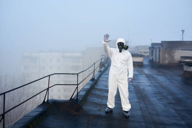 istock Worker scientist wearing protective coverall and gas mask doing ecological tests on the roof 1204628155