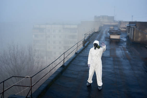 istock Worker scientist wearing protective coverall and gas mask doing ecological tests on the roof 1204628158