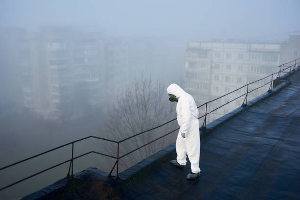istock Worker scientist wearing protective coverall and gas mask doing ecological tests on the roof 1204628163