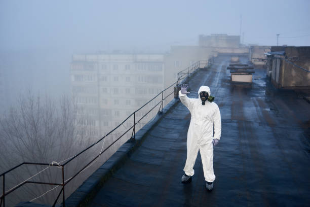 istock Worker scientist wearing protective coverall and gas mask doing ecological tests on the roof 1204628166