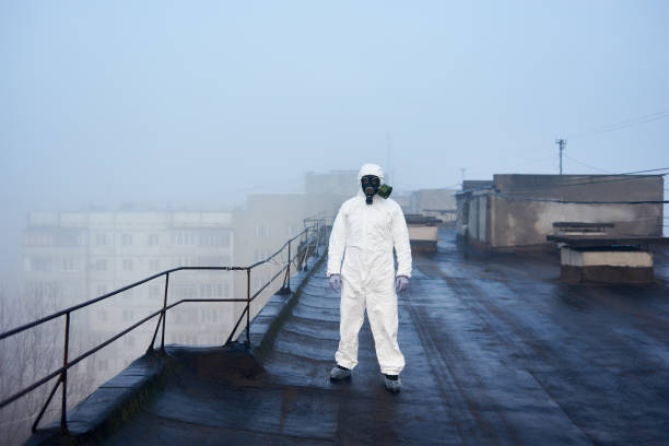 istock Worker scientist wearing protective coverall and gas mask doing ecological tests on the roof 1204628168