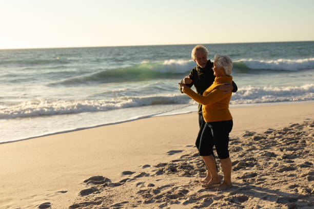 istock Old couple relaxing at the beach 1204628191
