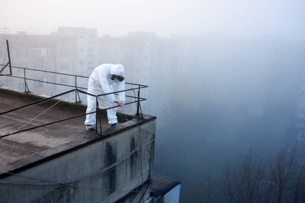 istock Worker scientist wearing protective coverall and gas mask doing ecological tests on the roof 1204628209