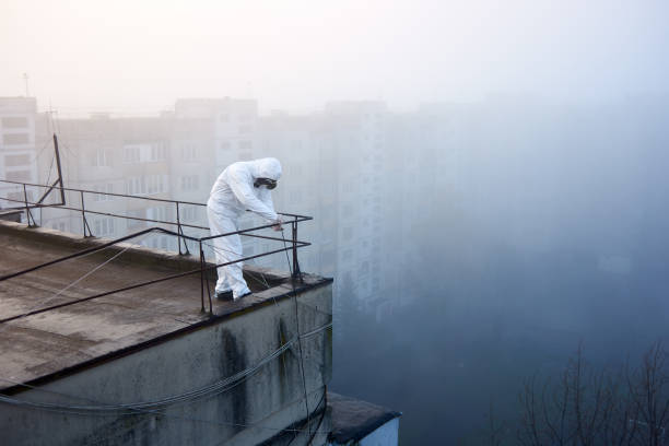 istock Worker scientist wearing protective coverall and gas mask doing ecological tests on the roof 1204628216
