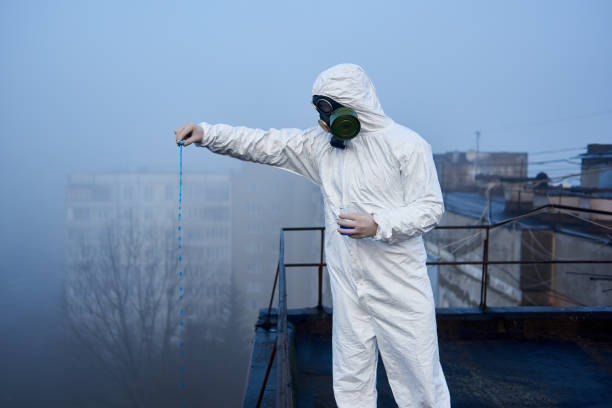 istock Worker scientist wearing protective coverall and gas mask doing ecological tests on the roof 1204628217