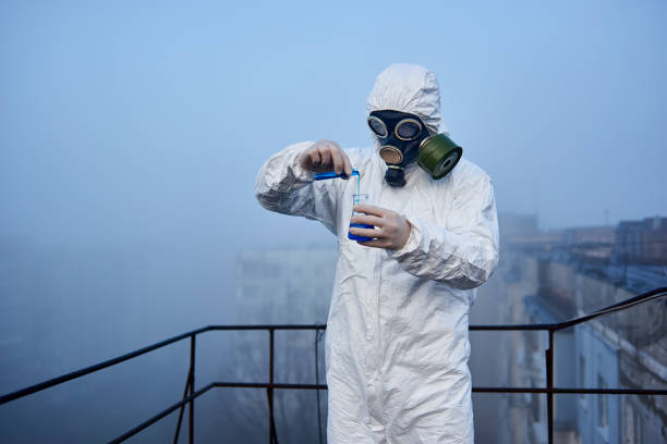 istock Worker scientist wearing protective coverall and gas mask doing ecological tests on the roof 1204628221