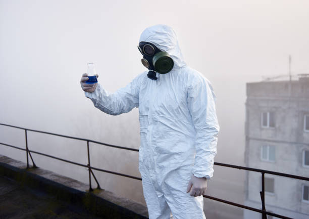 istock Worker scientist wearing protective coverall and gas mask doing ecological tests on the roof 1204628257