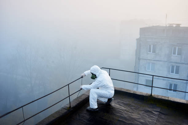 istock Worker scientist wearing protective coverall and gas mask doing ecological tests on the roof 1204628269