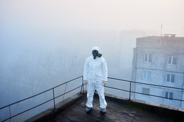 istock Worker scientist wearing protective coverall and gas mask doing ecological tests on the roof 1204628280