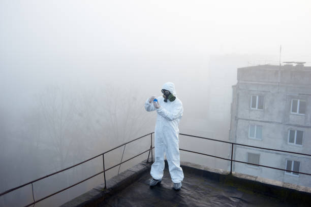 istock Worker scientist wearing protective coverall and gas mask doing ecological tests on the roof 1204628282