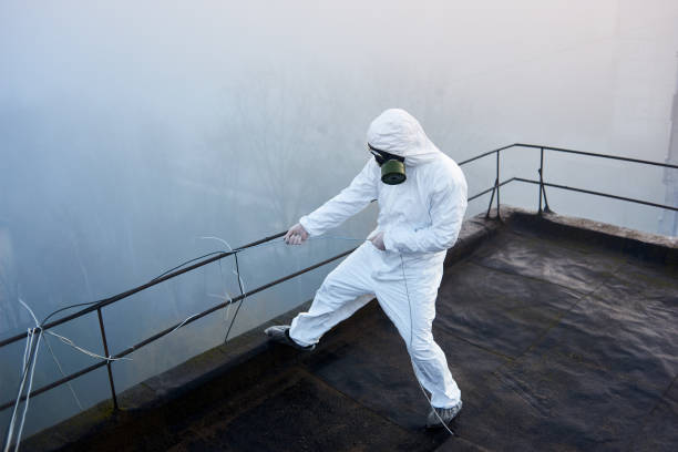 istock Worker scientist wearing protective coverall and gas mask doing ecological tests on the roof 1204628308