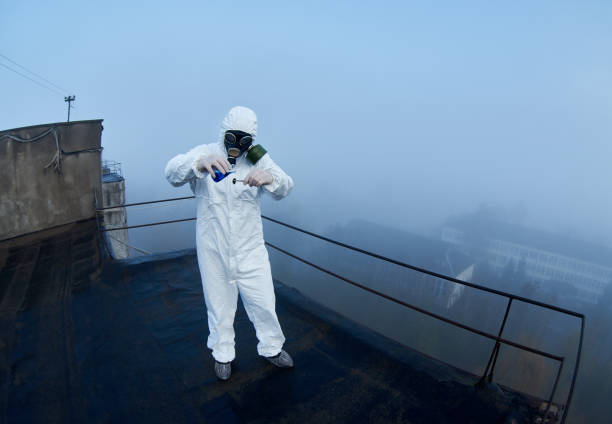 istock Worker scientist wearing protective coverall and gas mask doing ecological tests on the roof 1204628344