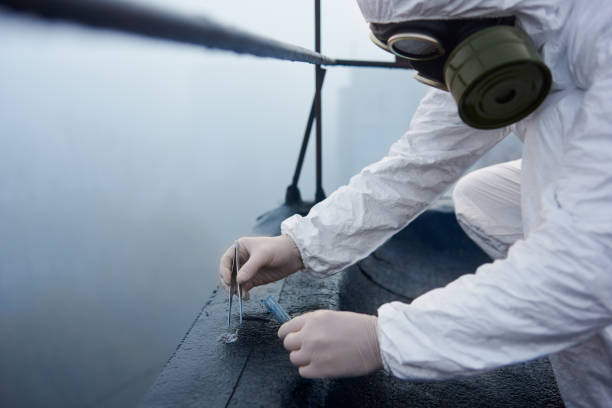 istock Worker scientist wearing protective coverall and gas mask doing ecological tests on the roof 1204628350