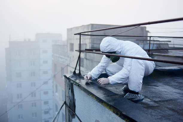 istock Worker scientist wearing protective coverall and gas mask doing ecological tests on the roof 1204628359