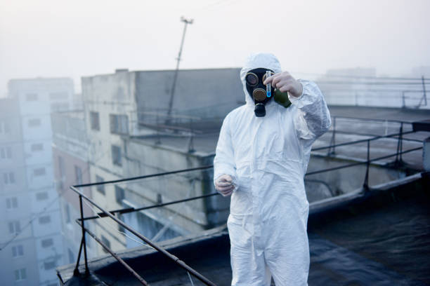 istock Worker scientist wearing protective coverall and gas mask doing ecological tests on the roof 1204628385