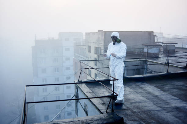 istock Worker scientist wearing protective coverall and gas mask doing ecological tests on the roof 1204628391