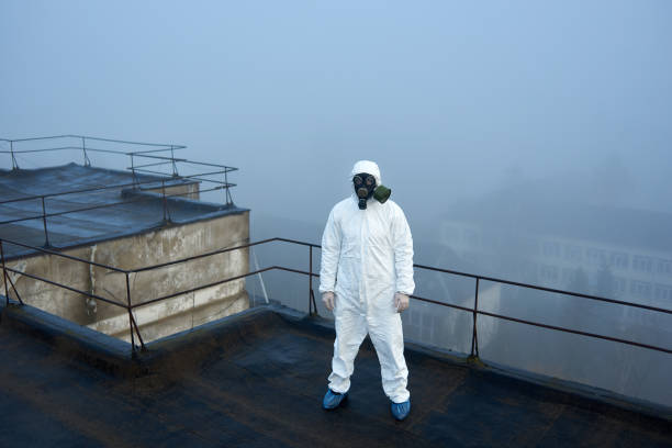 istock Worker scientist wearing protective coverall and gas mask doing ecological tests on the roof 1204628395