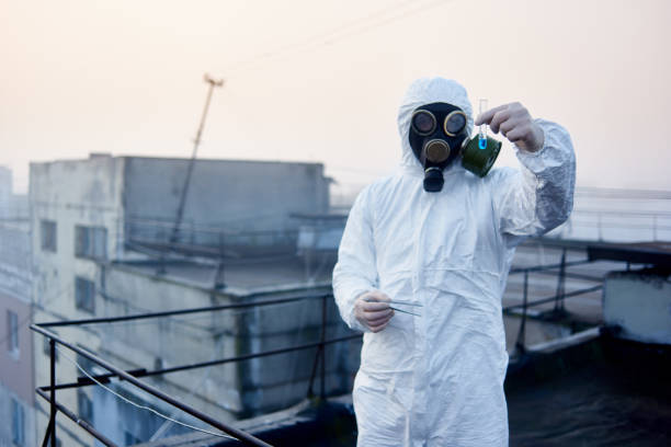istock Worker scientist wearing protective coverall and gas mask doing ecological tests on the roof 1204628403