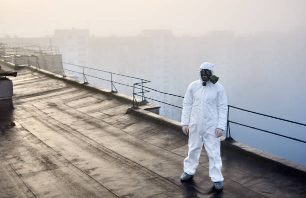 istock Worker scientist wearing protective coverall and gas mask doing ecological tests on the roof 1204628467