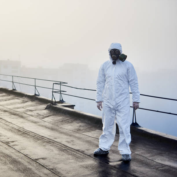 istock Worker scientist wearing protective coverall and gas mask doing ecological tests on the roof 1204628470