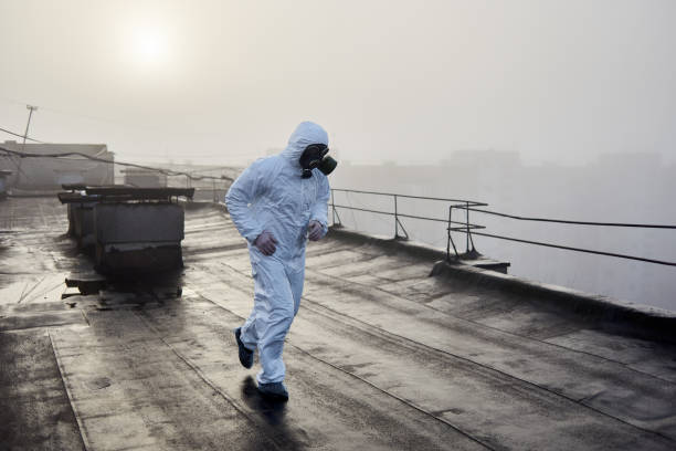 istock Worker scientist wearing protective coverall and gas mask doing ecological tests on the roof 1204628479