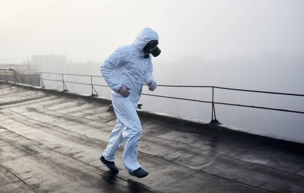 istock Worker scientist wearing protective coverall and gas mask doing ecological tests on the roof 1204628483