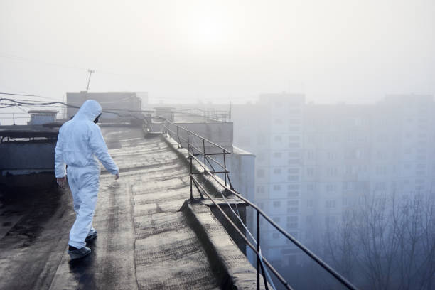 istock Worker scientist wearing protective coverall and gas mask doing ecological tests on the roof 1204628485