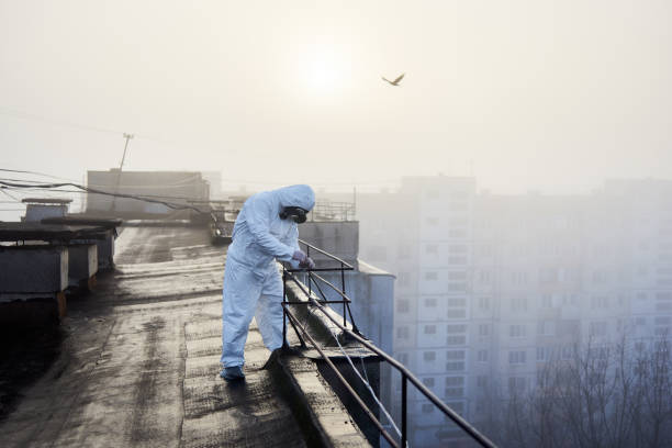 istock Worker scientist wearing protective coverall and gas mask doing ecological tests on the roof 1204628492