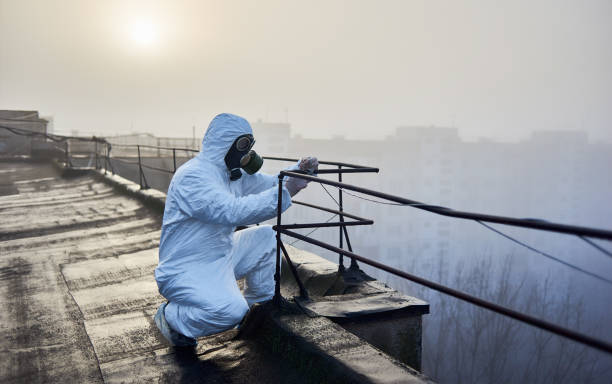 istock Worker scientist wearing protective coverall and gas mask doing ecological tests on the roof 1204628504