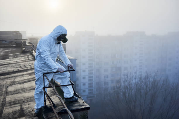 istock Worker scientist wearing protective coverall and gas mask doing ecological tests on the roof 1204628506