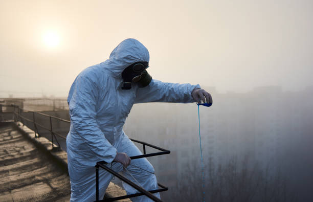 istock Worker scientist wearing protective coverall and gas mask doing ecological tests on the roof 1204628510