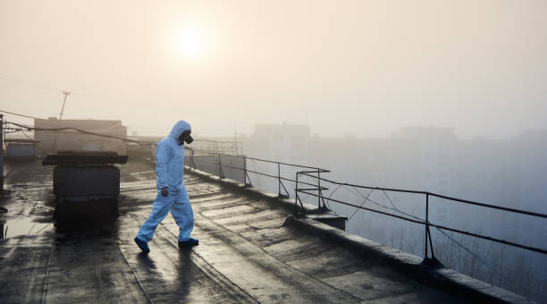 istock Worker scientist wearing protective coverall and gas mask doing ecological tests on the roof 1204628517