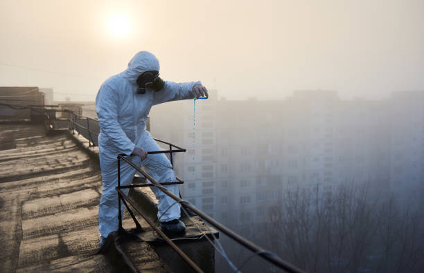 istock Worker scientist wearing protective coverall and gas mask doing ecological tests on the roof 1204628518